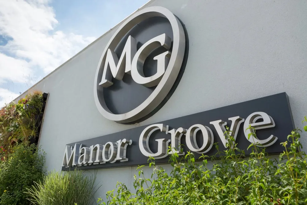 The Manor Grove sign and monogram on the venue's outside wall